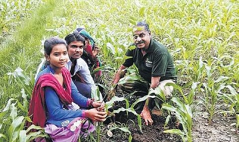 Raj Mohan with villagers at a site