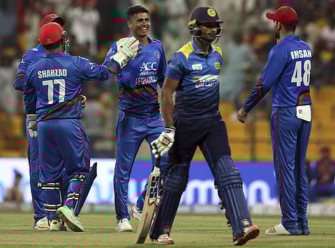 Afghanistan's Mujeeb Ur Rahman, center without cap, celebrates with teammates the dismissal of Sri Lanka's Dasun Shanaka, second right, during the Asia Cup match between Sri Lanka and Afghanistan in Abu Dhabi, United Arab Emirates, Monday, Sept. 17, 2018.