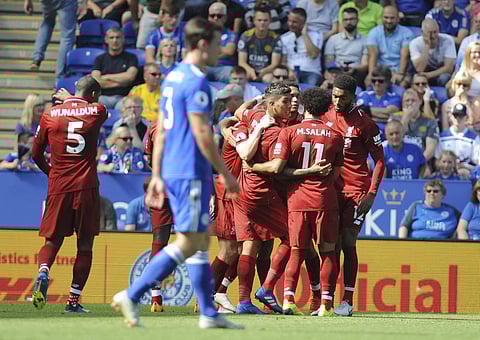 Liverpool's Roberto Firmino, centre, celebrates scoring his sides' second goal during the English Premier League soccer match between Leicester City and Liverpool at the King Power Stadium in Leicester, England, Saturday, Sept. 1, 2018. | AP