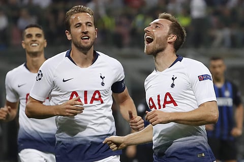 Tottenham midfielder Christian Eriksen, right, celebrates with his teammate Harry Kane after he scored his side's first goal during the Champions League, group B soccer match between Inter Milan and Tottenham Hotspur, at the Milan San Siro Stadium, Italy,