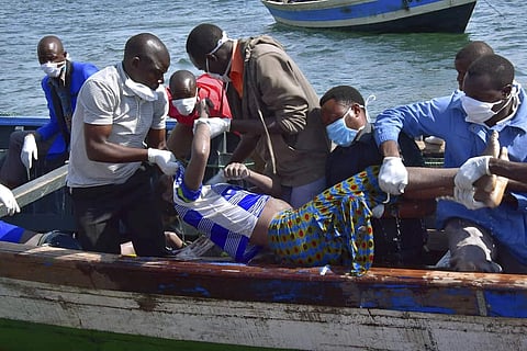 Rescuers retrieve a body from the water near Ukara Island in Lake Victoria, Tanzania | AP