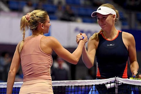 Camila Giorgi of Italy (L) is congraturated by Caroline Wozniacki of Denmark after winning their women's singles second round tennis match at the Pan Pacific Open tennis tournament in Tokyo on September 20, 2018.  | AFP