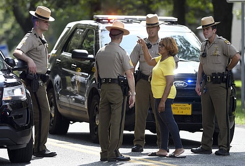 JoWanda Strickland- Lucas, of Aberdeen, Md., speaks to Maryland State Police near the perimeter of a scene where a shooting took place in Aberdeen, Md. on Thursday, Sept. 20, 2018. | AP