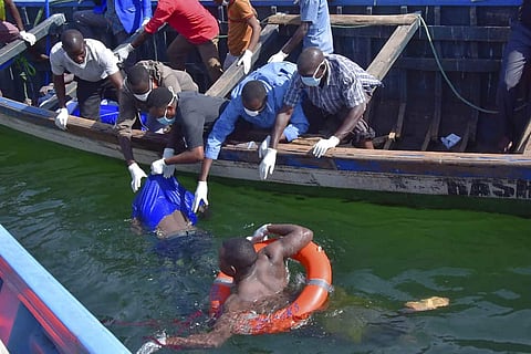 Hundreds of solemn people watched Friday as body after body was pulled from a capsized ferry that Tanzanian authorities said was badly overcrowded and upended in the final stretch before reaching shore. (Photo | AP)