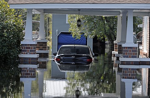 A submerged car sits in floodwaters in the aftermath of Hurricane Florence in Nichols, S.C., Friday, Sept. 21, 2018. Virtually the entire town is flooded and inaccessible except by boat, just two years after it was flooded by Hurricane Matthew. (Photo | A