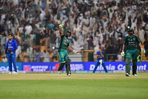 Pakistan's Hasan Ali (C) celebrates with Shoaib Malik at the end of the Asia Cup ODI match between Pakistan and Afghanistan at The Sheikh Zayed Stadium in Abu Dhabi on September 21, 2018. | AFP