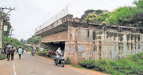 The incomplete flyover at Caramel Nagar. (Below) A damaged railing posing threat to passersby | RVK Rao