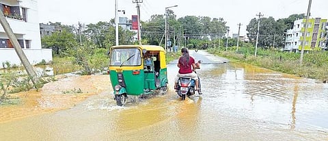 Motorists navigate through a flooded road at Kodichikkanahalli in Bengaluru  on Monday  | Nagaraja Gadekal