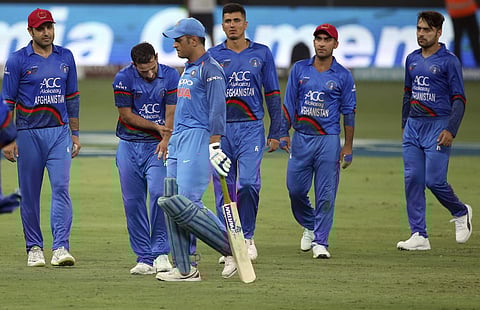 India's MS Dhoni leaves the field after losing his wicket as Afghanistan players watch | AP