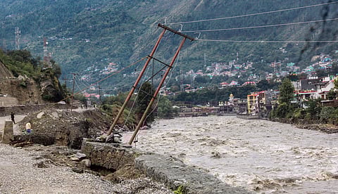 An electric pole on the bank of the swollen River Beas stands tilted after incessant rains in Kullu Himachal Pradesh Tuesday Sep 25 2018. | PTI