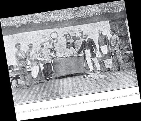 The proprietor of the mica mines examines the accounts at the Kuddusabad camp.