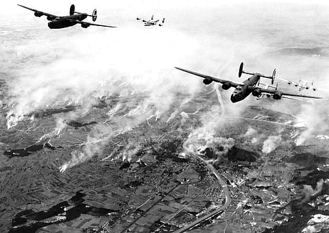 A formation of B-24s of Maj. General Nathan F. Twining's U.S. Army 15th Air Force thunders over the railway yards of Salzburg, Austria, on December 27, 1944. | Associated Press