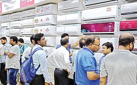 Customers selecting air conditioners at a showroom in Vijayawada. (Photo | P Ravindra babu/ EPS)