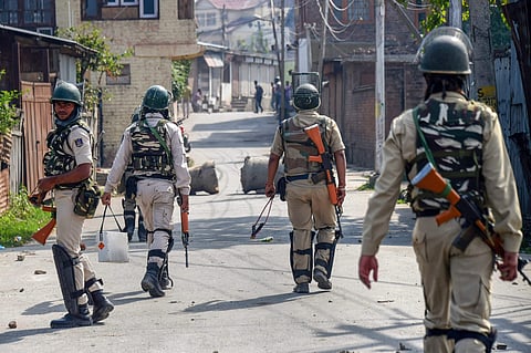 CRPF personnel patrol a street during the funeral procession of Mohammad Salim Malik a civilian who was killed in a firing incident during a search operation at Noorbagh Srinagar Thursday September 27 2018. | PTI