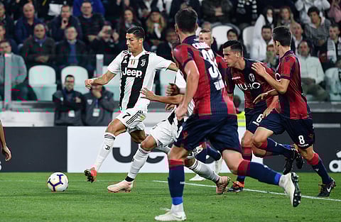 Juventus' Cristiano Ronaldo, left, goes for the ball during a Serie A soccer match between Juventus and Bologna at the Allianz Stadium in Turin, Italy (Photo | AP)