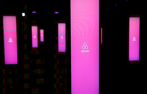 The logos of Airbnb are displayed at an Airbnb event in Tokyo. (Photo | Reuters)