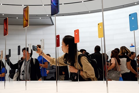 People take photos of the new Apple iPhones released following the product launch event at the Steve Jobs Theater in Cupertino, California. (Photo | Reuters)