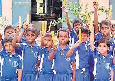 Students with wooden rulers