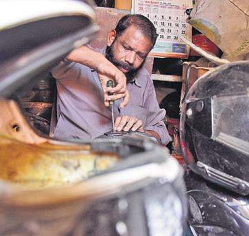 Vijayakumar, who has set his shack at Thakarapparambu in Thiruvananthapuram, has been into the maintenance and repair of helmets for many years  BP Deepu