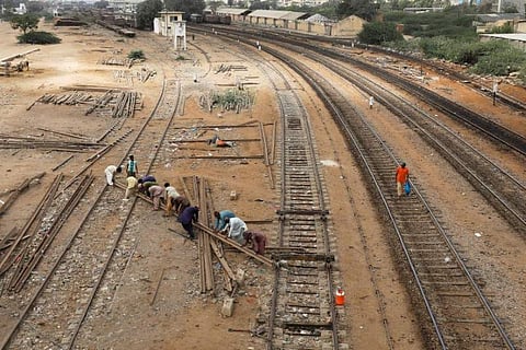 Labourers from the Pakistan Railways are seen working on railway tracks along City Station in Karachi, Pakistan. (Photo | Reuters)