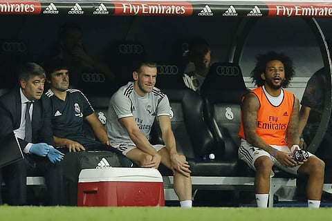 Real Madrid midfielder Gareth Bale (C) sits with Marcelo, right, on the substitutes bench during a La Liga match | AP
