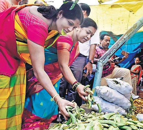 Mayor Gangambike Mallikarjun and Deputy Mayor Ramila Umashankar check out vegetables at KR Market on Saturday | PANDARINATH B