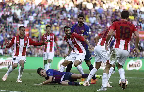 FC Barcelona's Munir El Haddadi, down, duels for the ball during the Spanish La Liga match against Athletic Bilbao at the Camp Nou stadium | AP