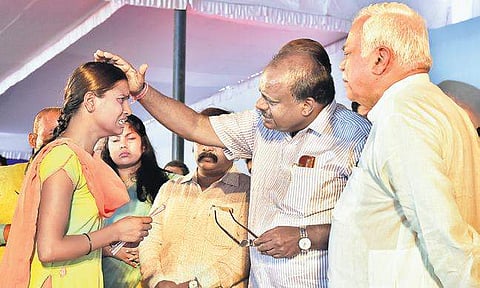A job aspirant breaks down during an interaction with Chief Minister H D Kumaraswamy at the job fair in Basavanagudi on Saturday