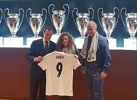 Ahed Tamimi was offered a Real jersey and posed for photos with Emilio Butragueno, the club's former striker (Photo | Twitter/Mohammed pal)