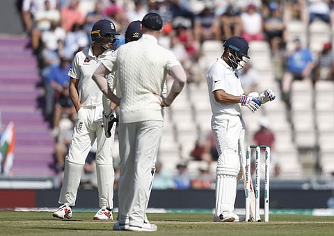 India's Virat Kohli, right, adjusts his gloves after an lbw review showed Kohli not out on review during play on the fourth day of the 4th cricket test match between England and India at the Ageas Bowl in Southampton. (Photo | AP)