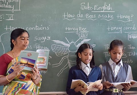 Radha Kumari K S teaching English to students of BBMP Higher Primary School near Shivajinagar. | (Pandarinath B | EPS)