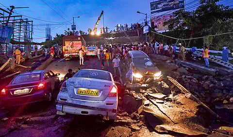 Vehicles are seen stuck after a section of Majerhat bridge collapsed in Kolkata Tuesday September 04, 2018. | PTI