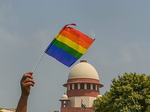 An activist waves a rainbow flag LGBT pride flag after the Supreme Court verdict which decriminalises consensual gay sex outside the Supreme Court. (Photo | PTI)