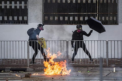 A protester throws a Molotov cocktail against police in the Sha Tin district of Hong Kong. (Photo| AFP)
