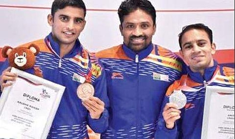 Chenanda A Kuttappa (centre) with boxers Amit Panghal (right) and Manish Kaushik (left)  | Express