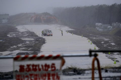 Workmen stand on a flooded road in Hamamatsu, Japan (Photo| AP)