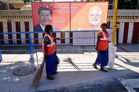 Corporation workers clean footpath and roads at OMR by which Narendra Modi and Chinese President Xi Jinping will go to Mahabalipuram from the city for two days meet. | (Photo | Debdutta Mallick/EPS)