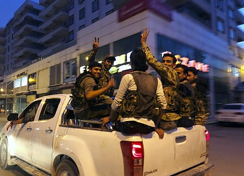 Turkish-backed Syrian opposition fighters from the Syrian National Army, flash the V-sign as they are driven through the town of Akcakale, Sanliurfa province, southeastern Turkey, on their way to enter over the border to Tel Abyad, Syria. (Photo | AP)