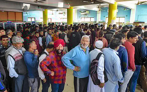 People stand in a queue at a telecom office to restore their mobile phones in Srinagar Monday Oct. 14 2019. | (Photo | PTI)