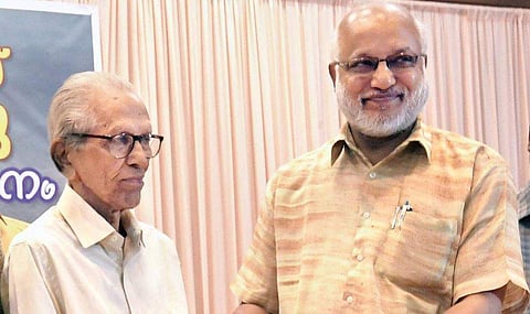 CPM politburo member M A Baby handing over the copy of Simon Britto’s book  to critic M K Sanu in Kochi on Monday | Express