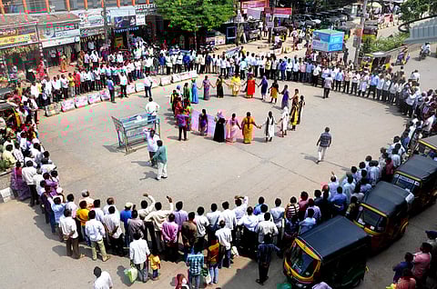 Members of TSRTC unions staged Human chain protest on 11th day of TSRTC union strike in Khammam on Tuesday.  (Photo | Special arrangement)