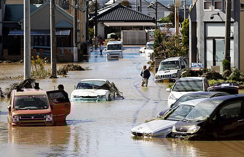 Vehicles are seen in mud water as Typhoon Hagibis hit the city in Sano. (Photo| AP)