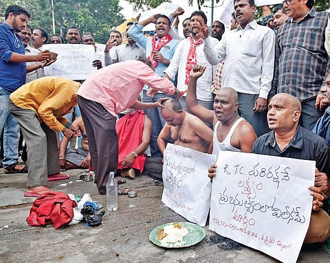Protesting employees get their heads shaved outside the Musheerabad RTC depot in Hyderabad on Wednesday | Vinay Madapu
