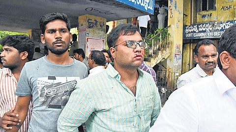 An activist who was injured in a clash between two YSRC groups at the DEO office in Kurnool on Wednesday following a row over egg tenders | Express