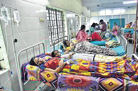 A scene from Avadi taluk hospital where one bed is being shared by two fever patients | P Jawahar