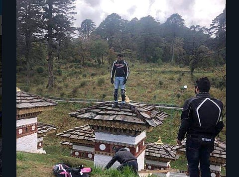 In photographs published on Twitter, Abhijit Ratan Hajare is seen standing on top of a 'chorten'. (Twitter Photo)