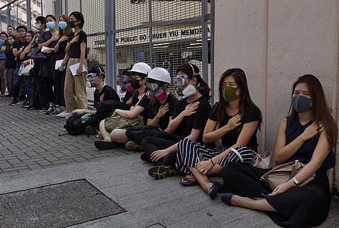 Supporters wearing masks attend a strike in Hong Kong condeming police shooting of a teenager during widespread violence in the semi-autonomous Chinese territory at pre-democracy protests that marred China's National Day. ( Photo | AP )