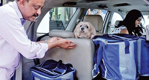 A resident of Holy Faith H20 shifting his pet dog along with other belongings from the soon-to-be-demolished building  | A Sanesh