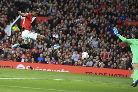 Manchester United's Marcus Rashford scores his side's opening goal against Liverpool at the Old Trafford stadium in Manchester. (Photo | AP)