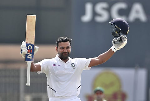 India's Rohit Sharma raises his bat and helmet to celebrate scoring double century during the second day of third and last cricket test match between India and South Africa in Ranchi, India. (Photo | AP)